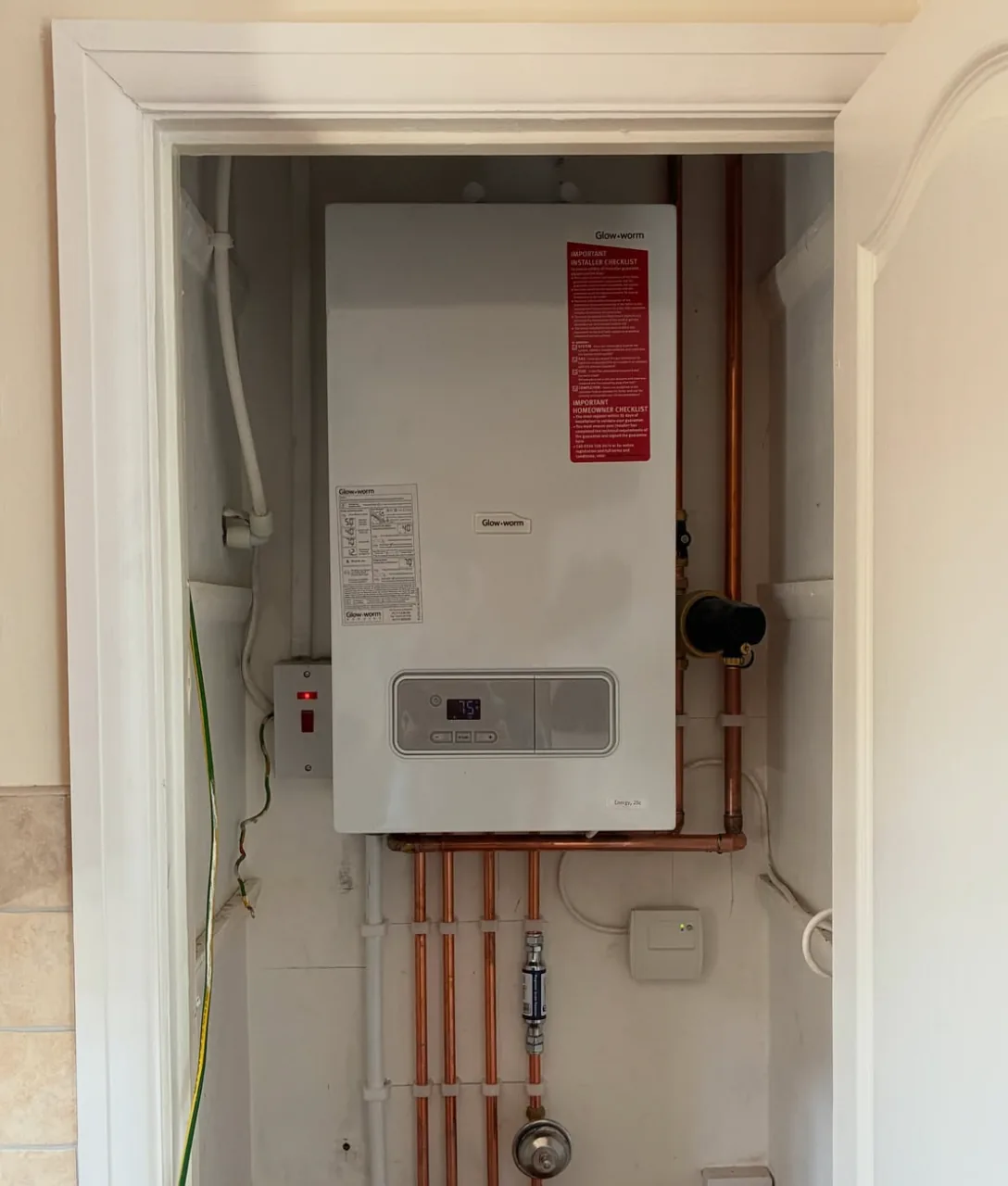 Boiler installation with neatly finished copper pipework by Infinite Plumbing & Heating
